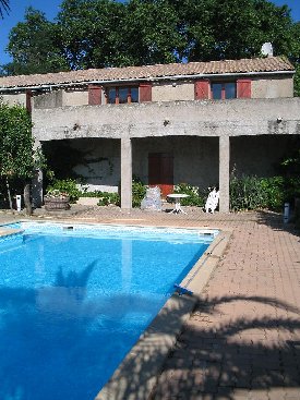 Covered terrace and swimming pool in canalside rental property